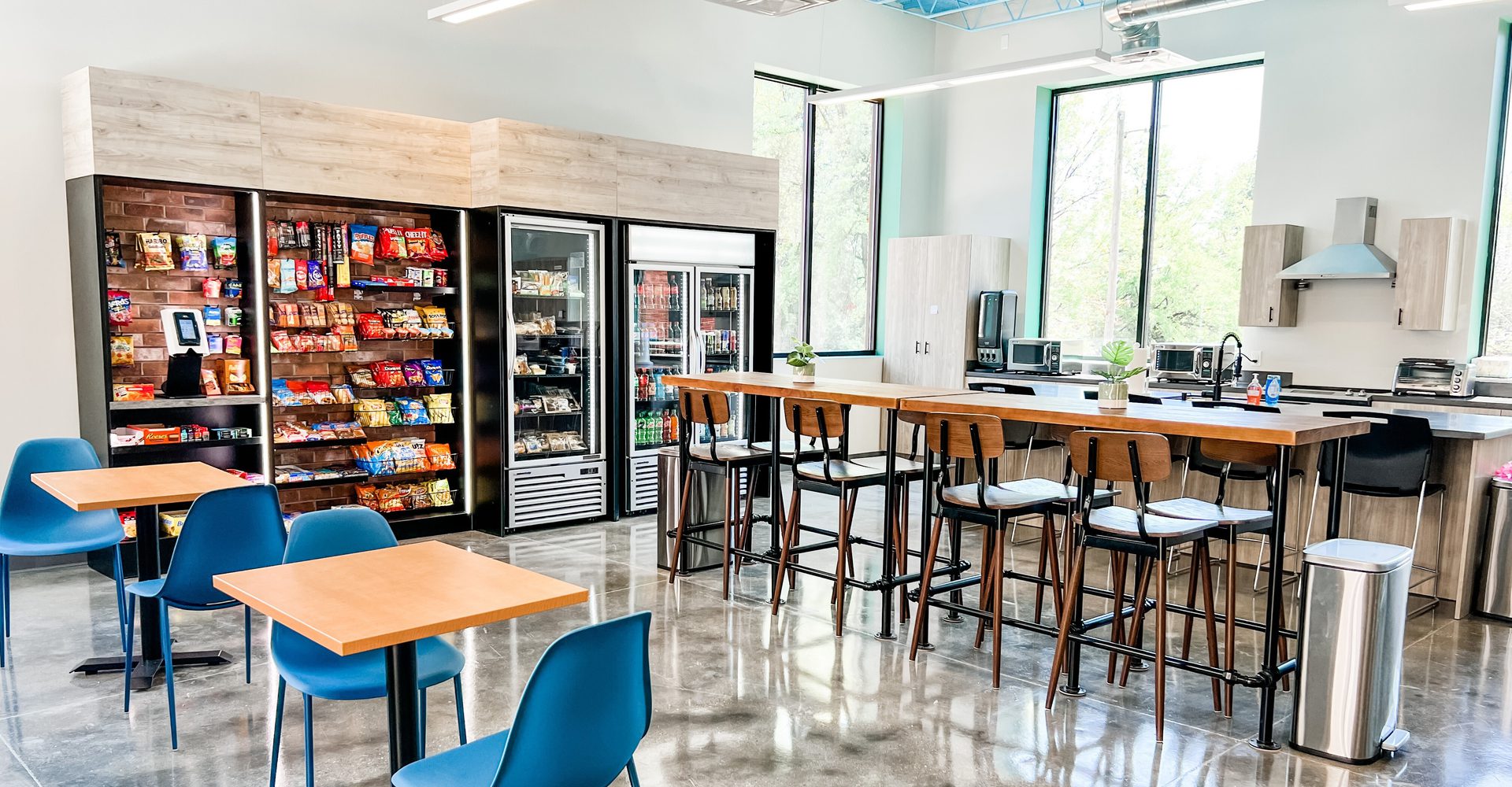 Image of corporate breakroom with chairs and vending machines