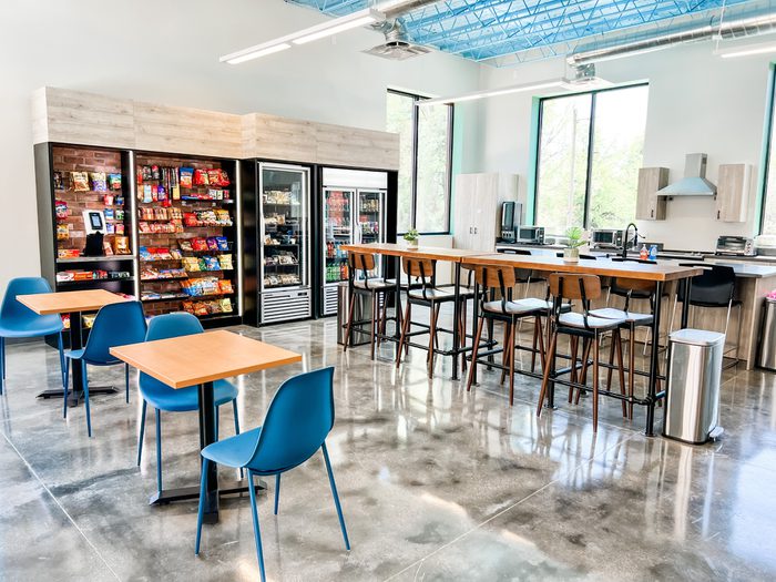 Image of corporate breakroom with chairs and vending machines