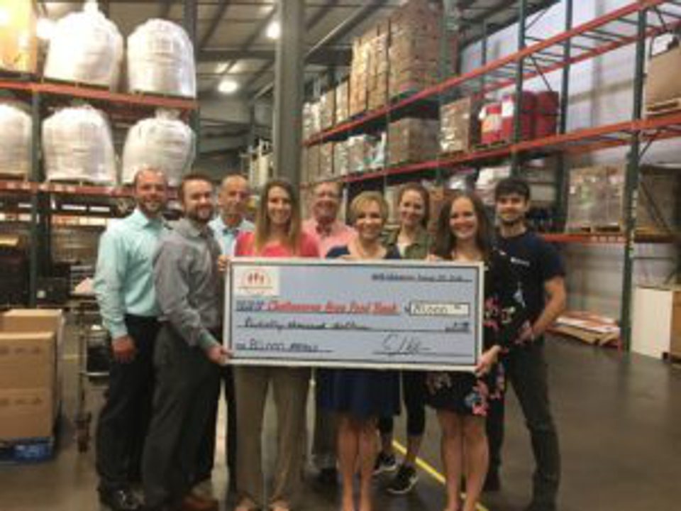 Nine people holding $5,000 check for Feeding the Future