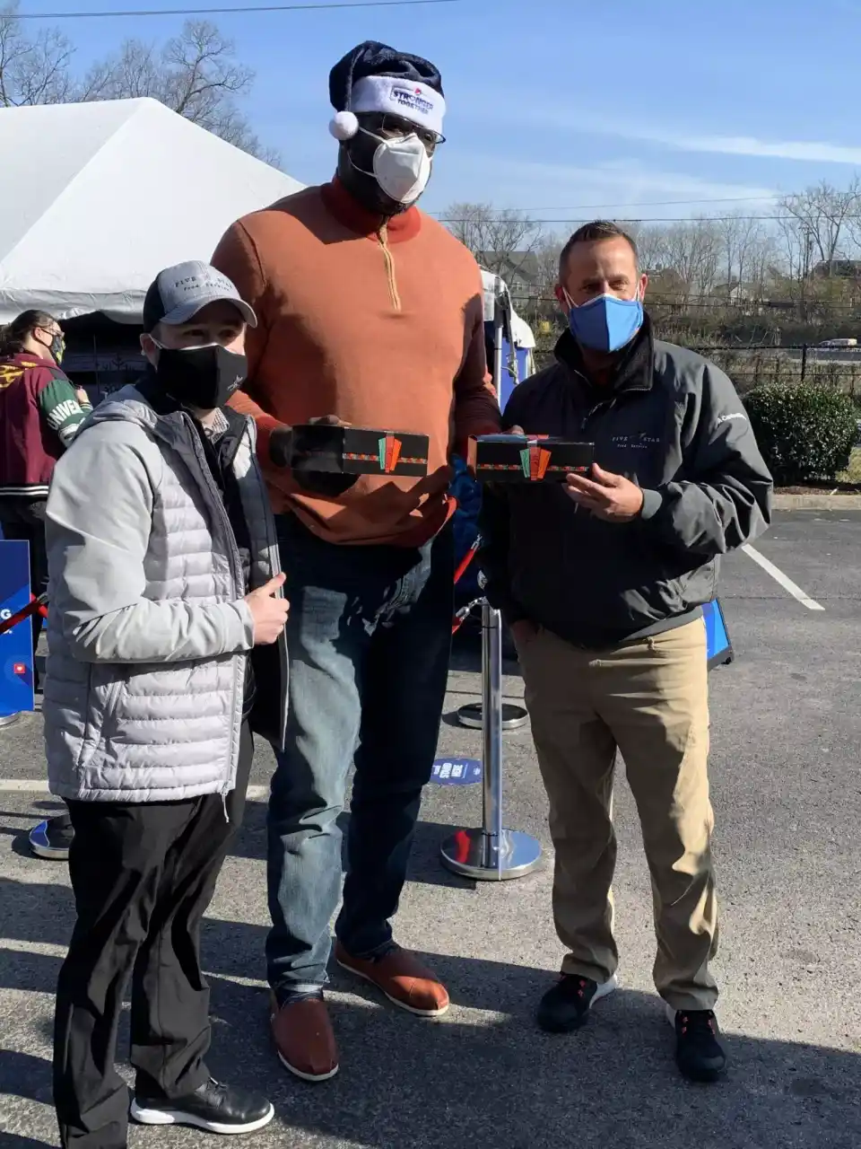 Two men taking picture with Shaq O'Neille