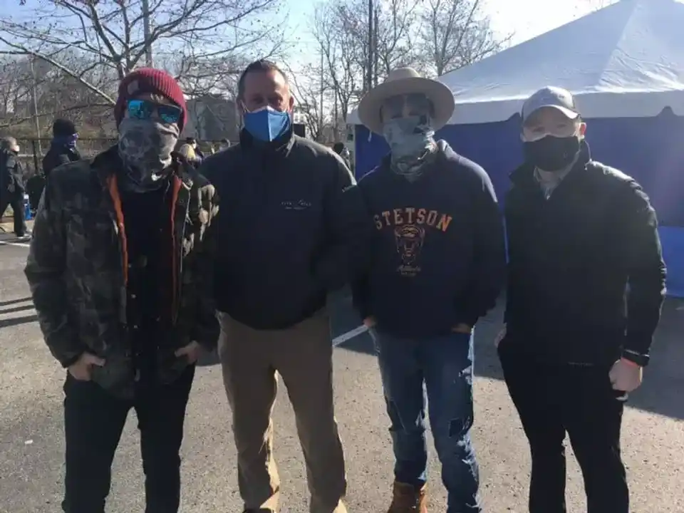 Four men wearing masks